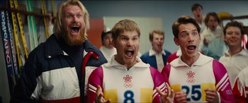 Movie still from “Eddie the Eagle” (2015), directed by Dexter Fletcher – A group of men standing next to each other; Medium shot, Low angle