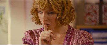 Movie still from “Eden Lake” (2008), directed by James Watkins – A person holding a finger to their lips; Close Up shot, Over the shoulder angle