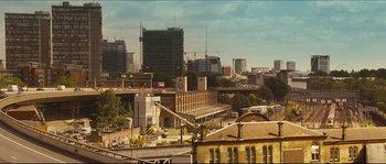 Movie still from “Eden Lake” (2008), directed by James Watkins – A view of a large city with buildings in the background; Extreme Wide shot, Low angle