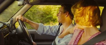 Movie still from “Eden Lake” (2008), directed by James Watkins – A man and a woman in a car driving down the road; Medium shot, Over the shoulder angle