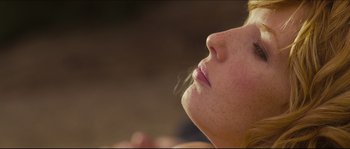 Movie still from “Eden Lake” (2008), directed by James Watkins – A woman's face with her eyes closed; Close Up shot, Low angle