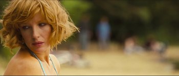 Movie still from “Eden Lake” (2008), directed by James Watkins – A woman's hair blowing in the wind on the beach; Close Up shot, Over the shoulder angle
