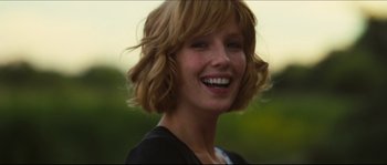 Movie still from “Eden Lake” (2008), directed by James Watkins – A person with short hair smiling; Close Up shot, Over the shoulder angle