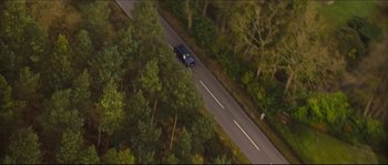 Movie still from “Eden Lake” (2008), directed by James Watkins – An aerial view of a car driving down the road; Extreme Wide shot, High angle
