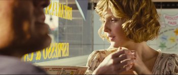 Movie still from “Eden Lake” (2008), directed by James Watkins – A woman sitting in front of a window holding a menu; Close Up shot, Over the shoulder angle