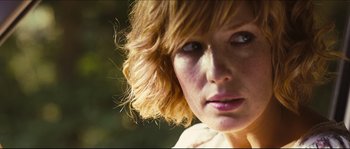Movie still from “Eden Lake” (2008), directed by James Watkins – A woman's face in a wooded area; Close Up shot, Low angle