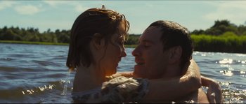 Movie still from “Eden Lake” (2008), directed by James Watkins – A man and a woman in a body of water; Medium shot, Low angle