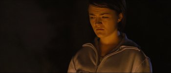 Movie still from “Eden Lake” (2008), directed by James Watkins – A young woman is looking sad in the dark; Close Up shot, Low angle