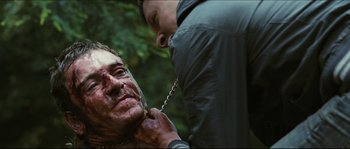 Movie still from “Eden Lake” (2008), directed by James Watkins – A man with a chain around his neck and a man with a chain around his neck; Close Up shot, Over the shoulder angle