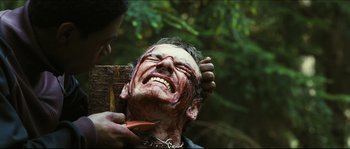 Movie still from “Eden Lake” (2008), directed by James Watkins – A man is being shaved by another man's face; Close Up shot, Over the shoulder angle