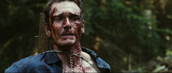Movie still from “Eden Lake” (2008), directed by James Watkins – A person with blood on his face; Close Up shot, Over the shoulder angle