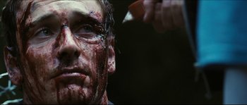 Movie still from “Eden Lake” (2008), directed by James Watkins – A man with blood all over his face and head; Close Up shot, Over the shoulder angle