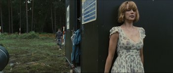 Movie still from “Eden Lake” (2008), directed by James Watkins – A woman and a man are walking in a forest; Medium shot, Over the shoulder angle