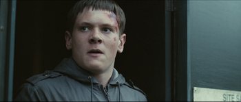 Movie still from “Eden Lake” (2008), directed by James Watkins – A young man with bruises on his face; Close Up shot, Low angle