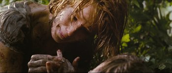 Movie still from “Eden Lake” (2008), directed by James Watkins – A woman's face with mud on her face; Close Up shot, Overhead angle