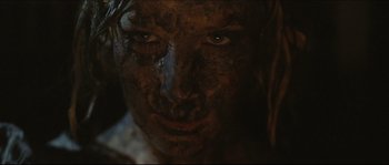 Movie still from “Eden Lake” (2008), directed by James Watkins – A person's face covered in dirt; Close Up shot, Low angle