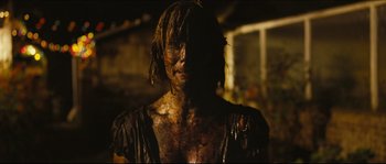 Movie still from “Eden Lake” (2008), directed by James Watkins – A person with a lot of dirt on their face; Close Up shot, Over the shoulder angle