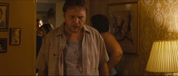Movie still from “Eden Lake” (2008), directed by James Watkins – A man in a plaid shirt is standing in front of a woman; Close Up shot, Over the shoulder angle