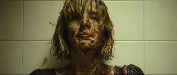 Movie still from “Eden Lake” (2008), directed by James Watkins – A person's face covered in mud; Close Up shot, Overhead angle