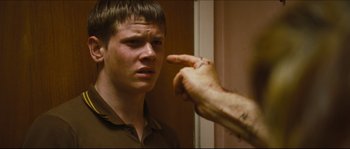 Movie still from “Eden Lake” (2008), directed by James Watkins – A young man looking into a bathroom mirror; Close Up shot, Over the shoulder angle
