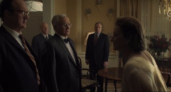 Movie still from “The Post” (2017), directed by Steven Spielberg – A group of men and a woman standing in front of a table; Medium shot, Over the shoulder angle