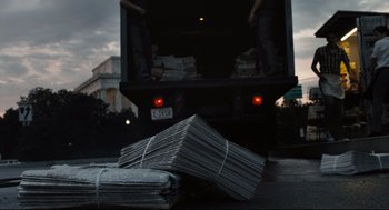 Movie still from “The Post” (2017), directed by Steven Spielberg – A truck full of newspapers on the side of the road; Medium shot, Low angle