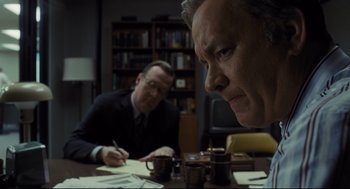 Movie still from “The Post” (2017), directed by Steven Spielberg – Two men sitting at a table with a cup of coffee; Close Up shot, Over the shoulder angle