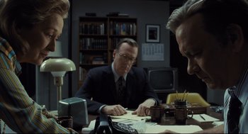 Movie still from “The Post” (2017), directed by Steven Spielberg – A group of people sitting around a table; Medium shot, Over the shoulder angle