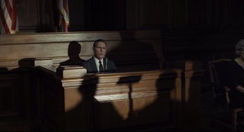 Movie still from “The Post” (2017), directed by Steven Spielberg – A man sitting in front of a judge in a courtroom; Wide shot, Low angle