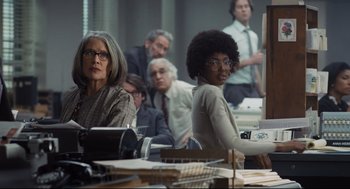 Movie still from “The Post” (2017), directed by Steven Spielberg – A group of people sitting at a table with papers; Medium shot, Low angle