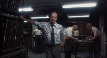 Movie still from “The Post” (2017), directed by Steven Spielberg – An older man in a dress shirt and a tie; Medium shot, Low angle