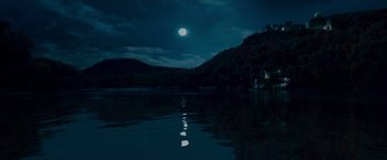 Movie still from “Edge of Darkness” (2010), directed by Martin Campbell – A body of water at night with a full moon in the background; Extreme Wide shot, Low angle