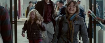 Movie still from “Edge of Darkness” (2010), directed by Martin Campbell – A group of people walking down a street; Medium shot, Over the shoulder angle