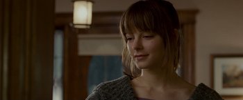Movie still from “Edge of Darkness” (2010), directed by Martin Campbell – A young woman with bangs is looking down at her face; Close Up shot, Over the shoulder angle