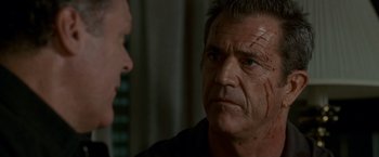 Movie still from “Edge of Darkness” (2010), directed by Martin Campbell – Mel gibson in a scene from the movie the expendables; Close Up shot, Over the shoulder angle