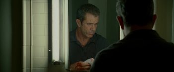 Movie still from “Edge of Darkness” (2010), directed by Martin Campbell – A man with a bandaged hand looking in the mirror; Close Up shot, Over the shoulder angle