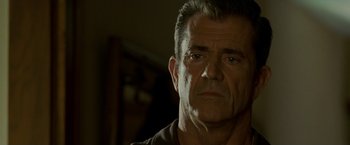 Movie still from “Edge of Darkness” (2010), directed by Martin Campbell – A person wearing a brown t - shirt; Close Up shot, Over the shoulder angle