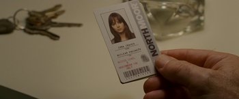 Movie still from “Edge of Darkness” (2010), directed by Martin Campbell – A person holding a north moor id card in their hand; Close Up shot, High angle
