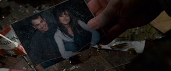 Movie still from “Edge of Darkness” (2010), directed by Martin Campbell – A person holding a picture of a woman; Extreme Close Up shot, Overhead angle