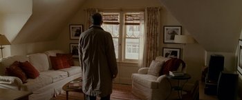 Movie still from “Edge of Darkness” (2010), directed by Martin Campbell – An older man standing in front of a large window; Wide shot, High angle