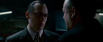 Movie still from “Edge of Darkness” (2010), directed by Martin Campbell – A man in a suit talking to another man in a suit; Close Up shot, Over the shoulder angle