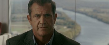 Movie still from “Edge of Darkness” (2010), directed by Martin Campbell – A person wearing a suit and tie; Close Up shot, Over the shoulder angle