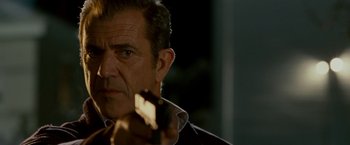 Movie still from “Edge of Darkness” (2010), directed by Martin Campbell – A person holding a cell phone; Close Up shot, Low angle