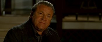 Movie still from “Edge of Darkness” (2010), directed by Martin Campbell – A person wearing a shirt and tie; Close Up shot, Over the shoulder angle