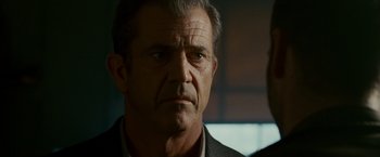 Movie still from “Edge of Darkness” (2010), directed by Martin Campbell – A person wearing a suit and tie; Close Up shot, Over the shoulder angle