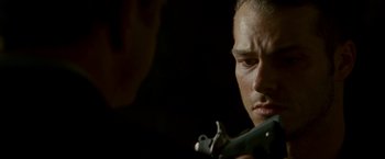 Movie still from “Edge of Darkness” (2010), directed by Martin Campbell – A person holding a gun; Close Up shot, Over the shoulder angle