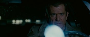 Movie still from “Edge of Darkness” (2010), directed by Martin Campbell – A man with a flashlight in a dark room; Close Up shot, Low angle
