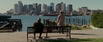 Movie still from “Edge of Darkness” (2010), directed by Martin Campbell – Two people sitting on a bench looking out at the water; Extreme Wide shot, Over the shoulder angle