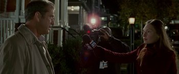 Movie still from “Edge of Darkness” (2010), directed by Martin Campbell – A person is being filmed by a camera man; Medium shot, Over the shoulder angle