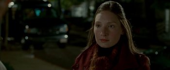 Movie still from “Edge of Darkness” (2010), directed by Martin Campbell – A young woman wearing a red jacket and a scarf; Close Up shot, Over the shoulder angle
